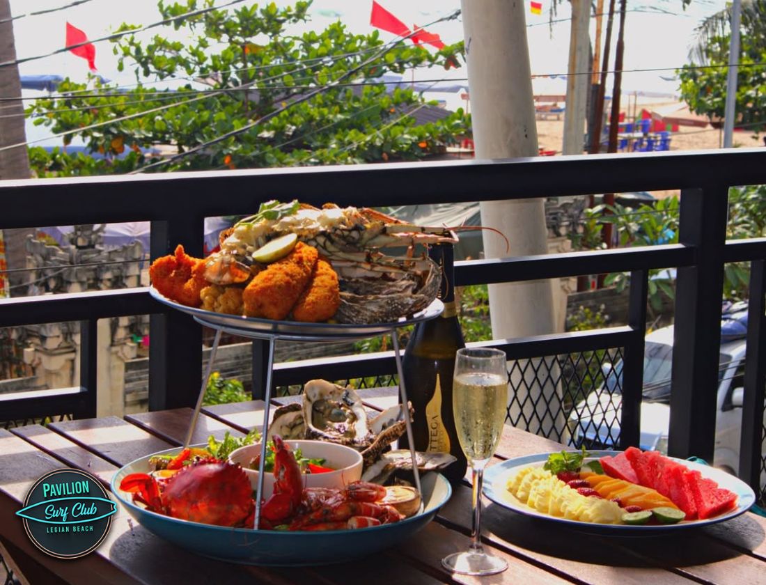 Sunset cocktails and beachfront table at Pavilion Surf Club Sunset cocktails and beachfront table at Pavilion Surf Club