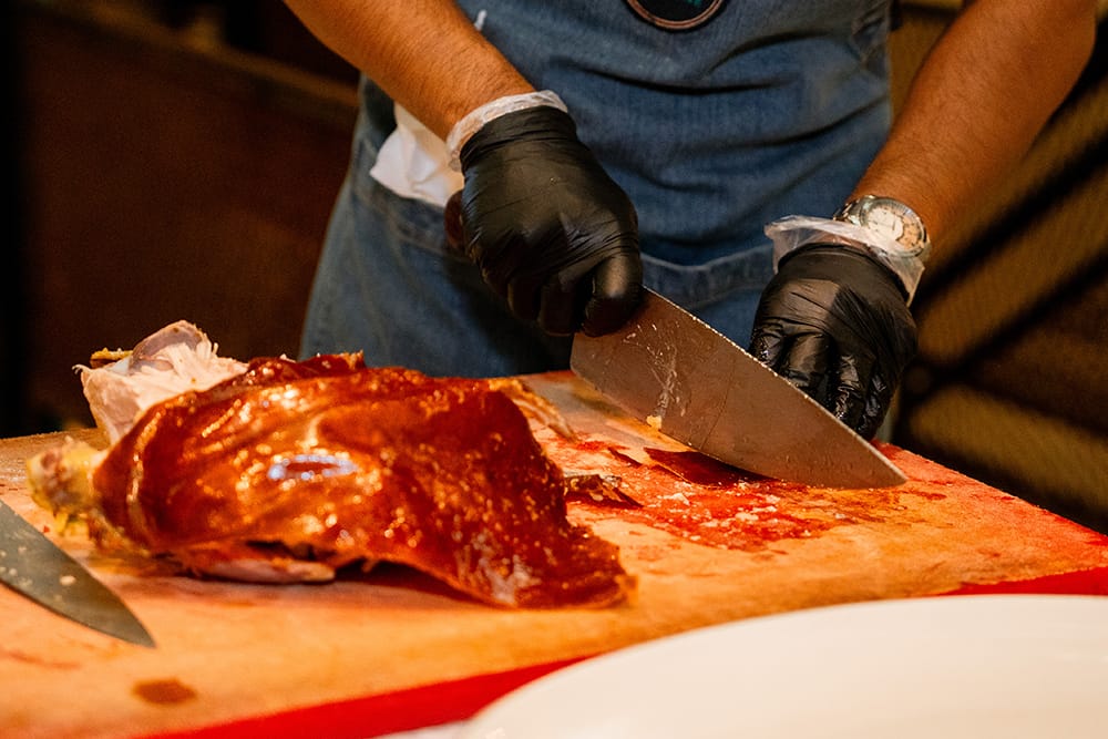 Chef preparing roast meat for a Pavilion Surf Club event buffet